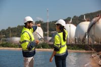 chemical engineer works at refinery storage tanks